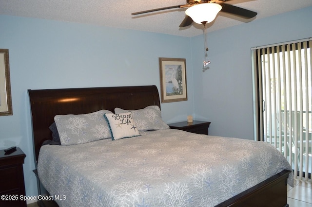 bedroom with a ceiling fan and a textured ceiling