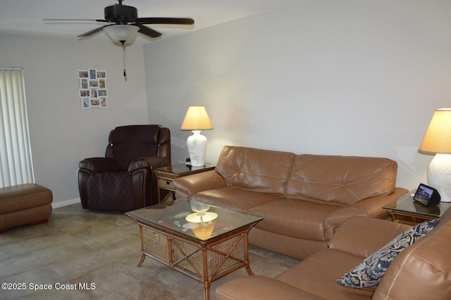 living room featuring light tile patterned floors, a ceiling fan, and baseboards