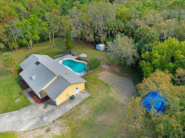 birds eye view of property with a view of trees