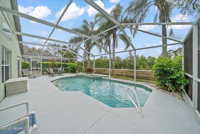 outdoor pool with a lanai and a patio area