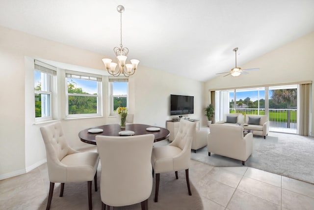 dining area featuring lofted ceiling, light tile patterned floors, plenty of natural light, and baseboards