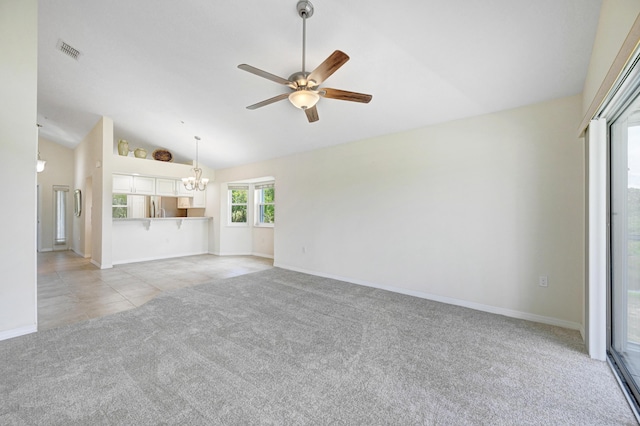 unfurnished living room featuring light tile patterned floors, light colored carpet, ceiling fan with notable chandelier, visible vents, and vaulted ceiling