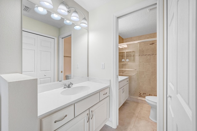 bathroom featuring visible vents, vanity, a shower stall, and toilet