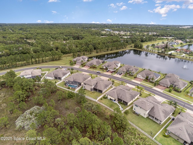 birds eye view of property with a water view, a wooded view, and a residential view