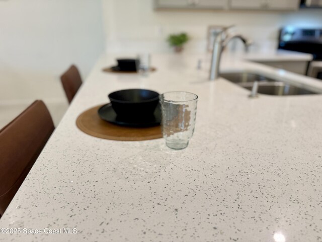 room details featuring light countertops and a sink