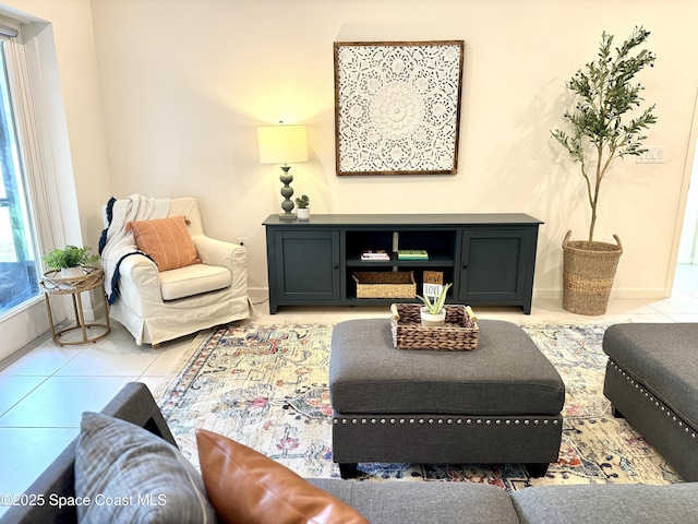 living area with light tile patterned floors and baseboards