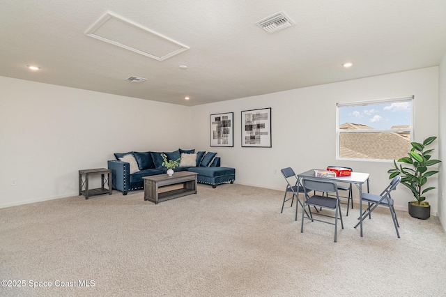 living room with attic access, recessed lighting, visible vents, and carpet flooring