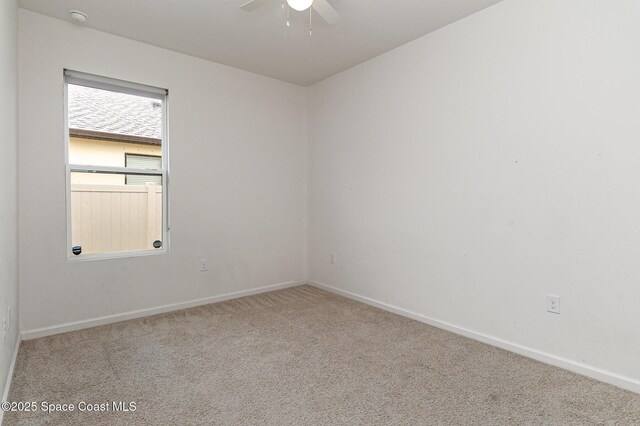 unfurnished room with ceiling fan, carpet floors, and baseboards