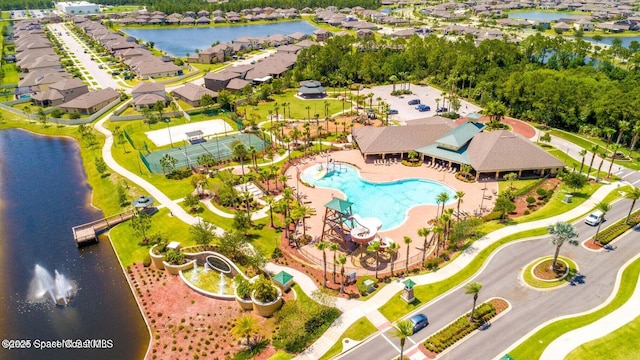 drone / aerial view featuring a water view and a residential view