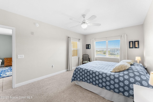 bedroom featuring ceiling fan, carpet, and baseboards