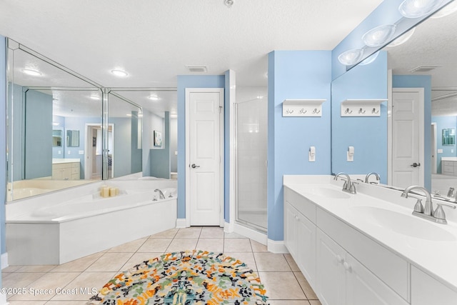 bathroom with visible vents, a sink, and tile patterned floors