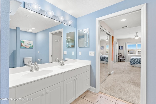 full bathroom featuring ensuite bathroom, tile patterned flooring, a sink, and visible vents