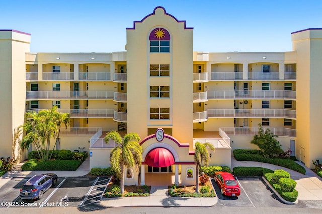 view of building exterior featuring uncovered parking