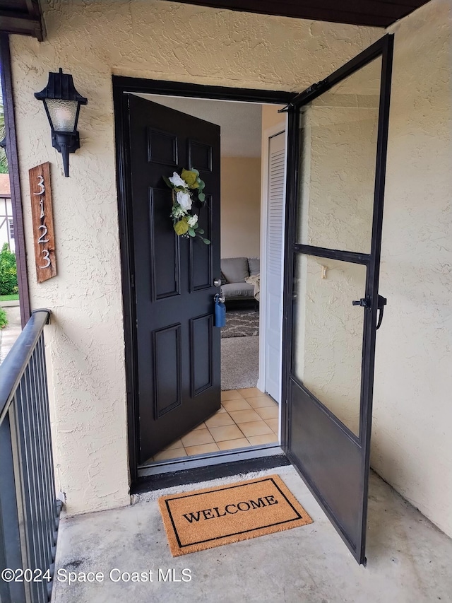 entrance to property with stucco siding