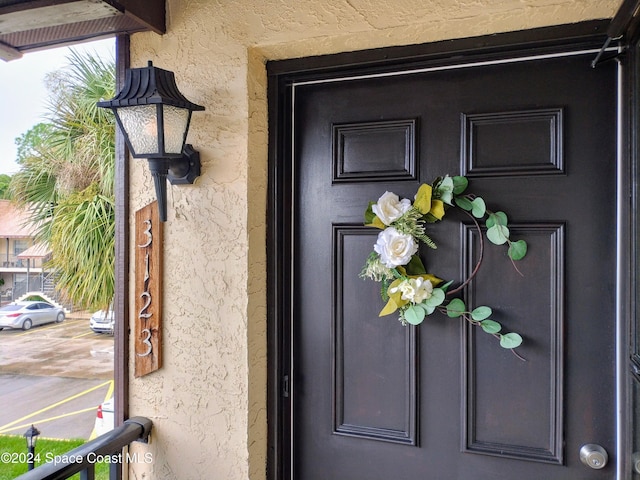 view of exterior entry with stucco siding