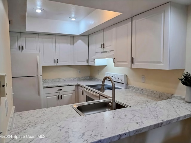 kitchen featuring under cabinet range hood, white appliances, a sink, white cabinets, and light stone countertops