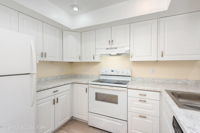 kitchen with white cabinets, under cabinet range hood, white appliances, and light countertops