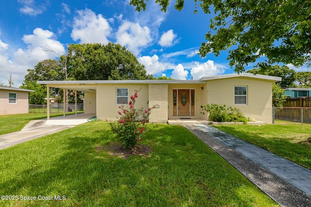 ranch-style house featuring an attached carport, fence, concrete driveway, stucco siding, and a front yard