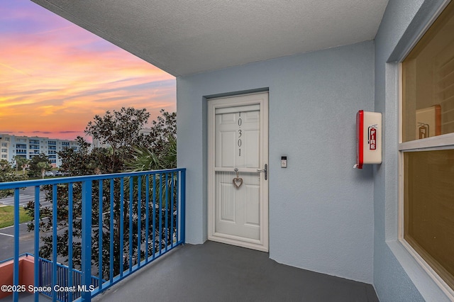 view of balcony at dusk