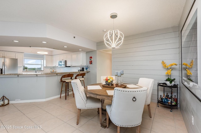 dining room with light tile patterned floors, recessed lighting, and a notable chandelier