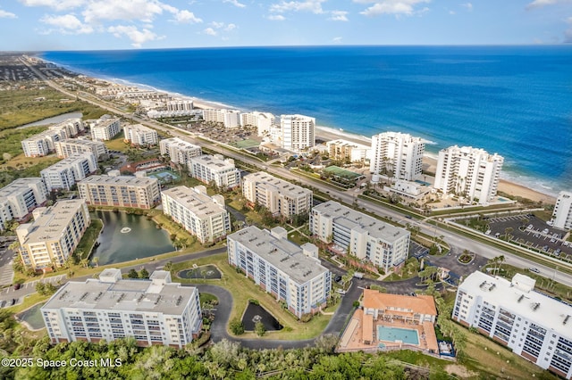 birds eye view of property with a water view and a city view