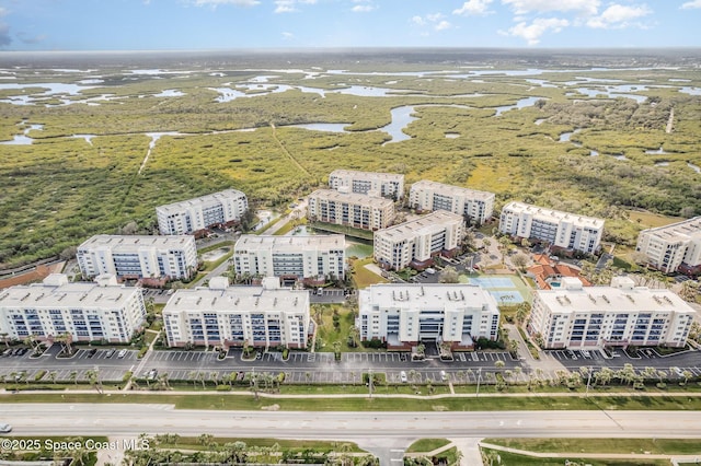 drone / aerial view featuring a water view and a view of city