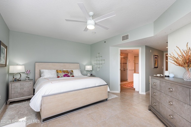 bedroom with light tile patterned floors, a textured ceiling, a ceiling fan, visible vents, and baseboards