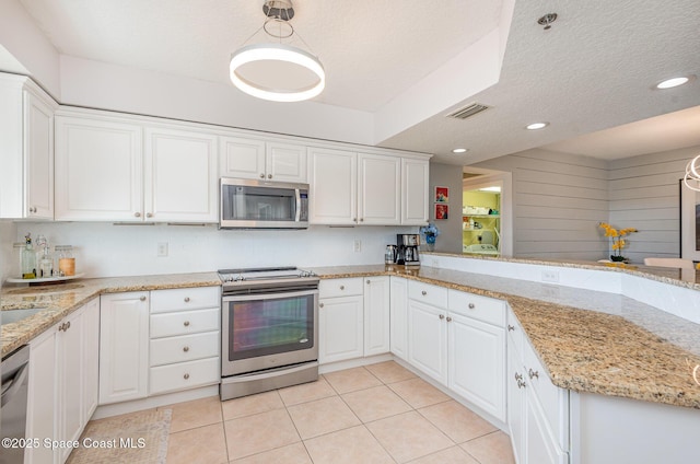 kitchen featuring light tile patterned floors, visible vents, appliances with stainless steel finishes, a textured ceiling, and white cabinetry