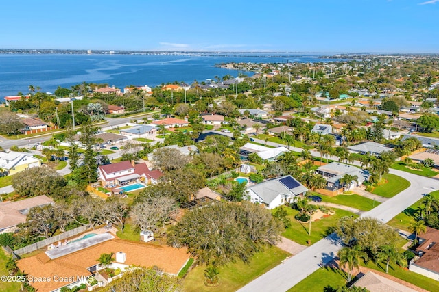 drone / aerial view with a water view and a residential view