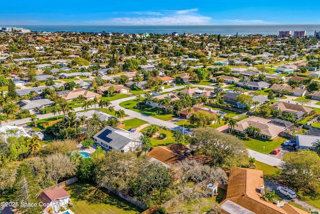 birds eye view of property with a water view and a residential view