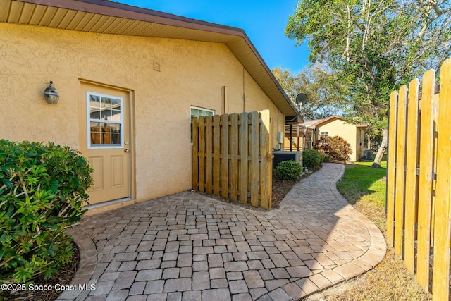 view of home's exterior featuring fence and stucco siding