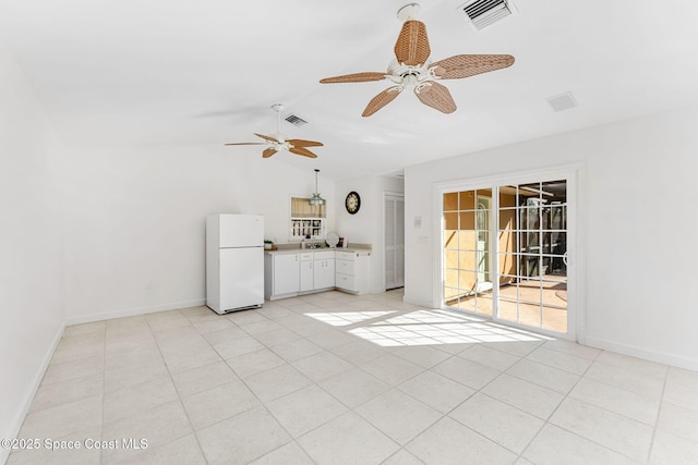 interior space featuring lofted ceiling, visible vents, and baseboards