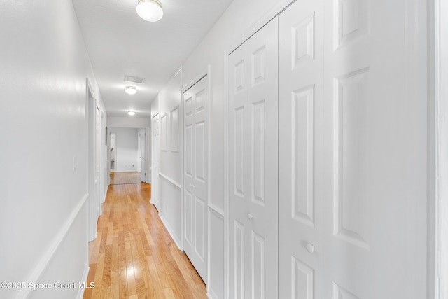 hall with light wood-style floors