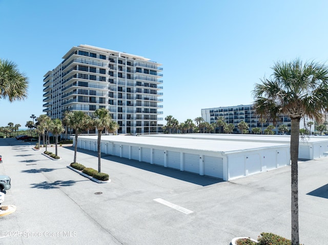 view of building exterior with community garages