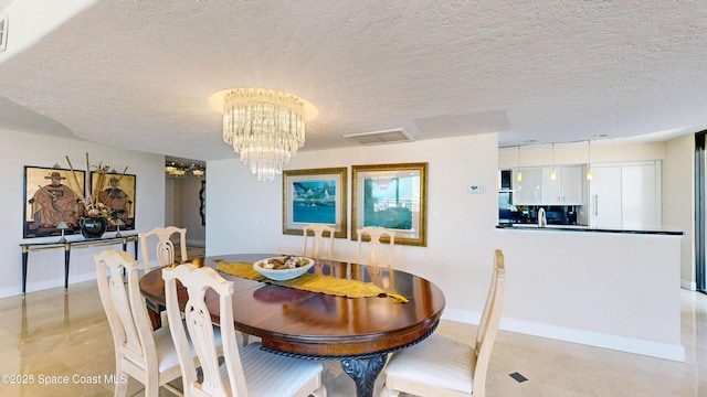 dining space with light tile patterned floors, a textured ceiling, visible vents, and a notable chandelier