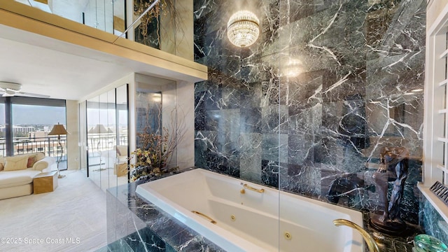 bathroom with a whirlpool tub, stone wall, and tile walls