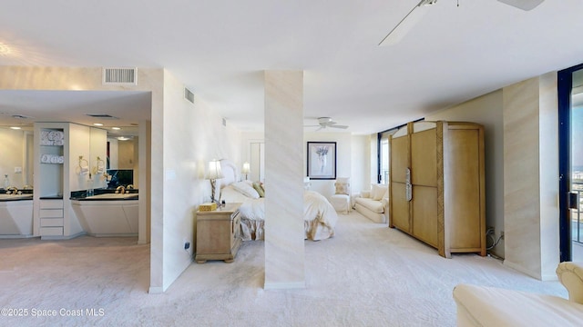 unfurnished bedroom featuring a ceiling fan, light colored carpet, and visible vents