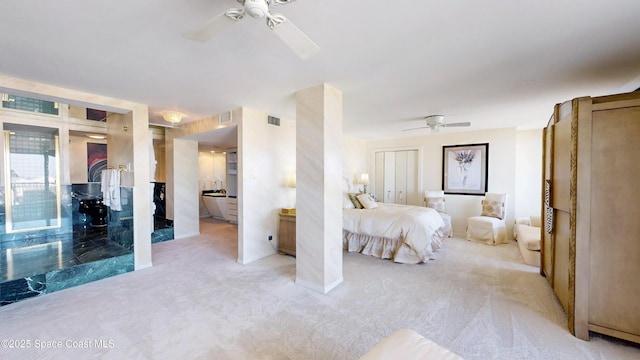 bedroom featuring light carpet, ceiling fan, and visible vents