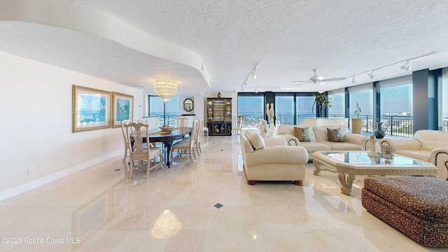 living area with a textured ceiling, a wealth of natural light, and baseboards