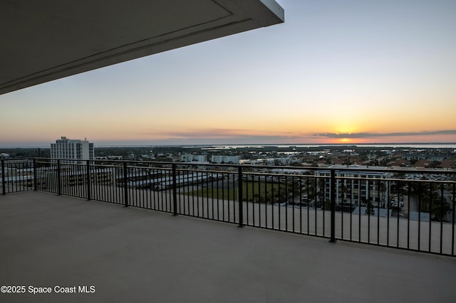 view of patio featuring a balcony and a view of city