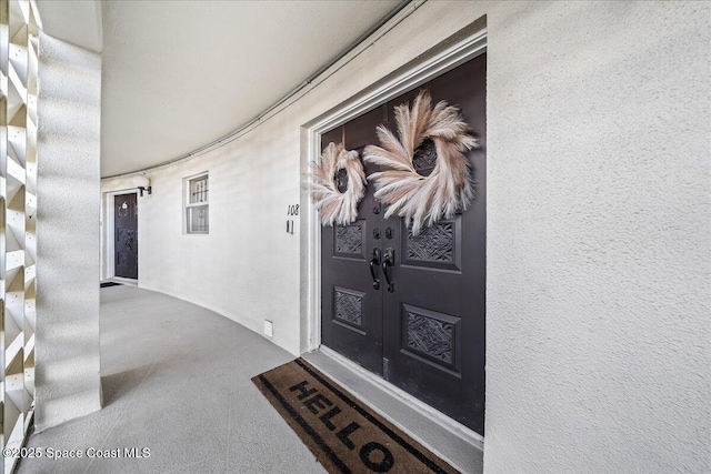 doorway to property with french doors and stucco siding