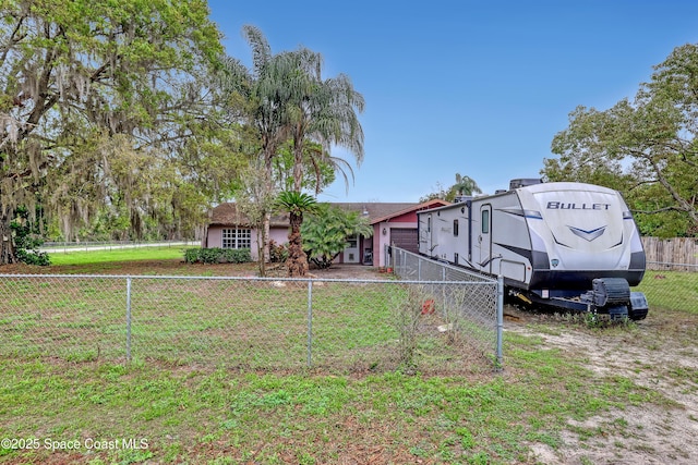 view of front of home featuring a front yard and a fenced backyard