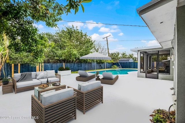 view of patio with a fenced in pool, a sunroom, a fenced backyard, and an outdoor hangout area