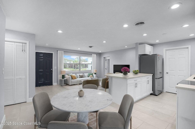 dining room featuring recessed lighting, visible vents, light tile patterned flooring, a textured ceiling, and baseboards