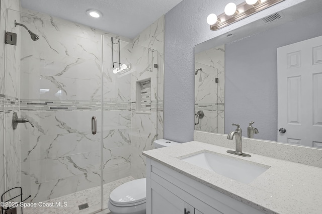 full bath with a textured wall, vanity, a marble finish shower, and toilet