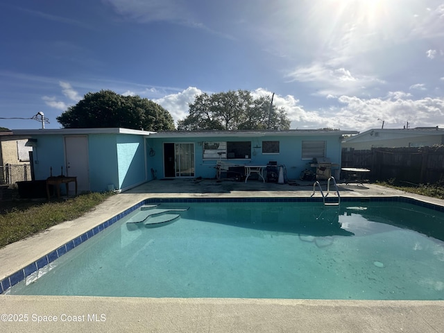 view of swimming pool with a fenced in pool, fence, a grill, and a patio area