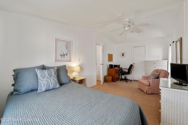 carpeted bedroom featuring a textured ceiling, ceiling fan, and lofted ceiling