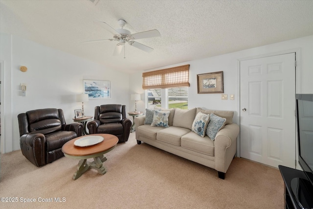 living room with light carpet, a textured ceiling, and a ceiling fan