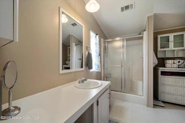 full bathroom with a stall shower, visible vents, and a textured ceiling