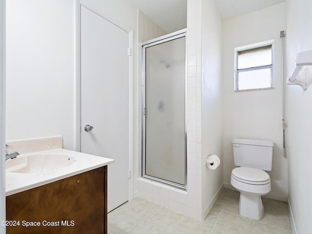 bathroom featuring toilet, tile patterned floors, a shower stall, and vanity